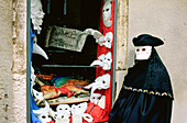 Masked man at masks shop window. Venice. Italy