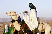 Tuareg riding a camel. Tassili n Ajjer. Djanet oasis. South Sahara. Algeria