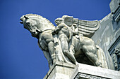 Detail of statue on top of the central railway station main facade. Milan. Italy