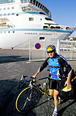 Bicyclist in front of ship at harbour. Bastia, Corsica Island. France