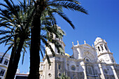 Cathedral facade and palm trees at fore. Cádiz, Spain
