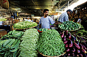 Vegetables stall and vendor. Central Market. Port Louis. Mauritius