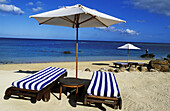 Sunshade and deck chairs on Teh Beach. Hotel Resort Oberoi. Pointe Aux Piments. Mauritius