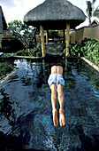 Diving in a private villa swimming pool. Hotel Resort Oberoi. Pointe Aux Piments. Mauritius
