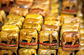 Small elephant figures for sale as offerings. Erawan Shrine (many believers and pilgrims come here form praying and getting blessings). Modern Town. Bangkok. Thailand