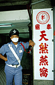 Warden protecting from pollution and chinese ideogram. Chinatown. Bangkok. Thailand