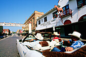 Cowboys driving convertible car at Stockyards, Fort Worth. Texas, USA