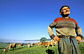 Mr Grandchavin and his Montbéliarde cows and calves. Near Malbuisson by Lake Saint-Point. Doubs. Franche-Comte. France