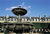 Fountain at Place des Vosges (formerly Place Royal, planned in 1603). Paris. France
