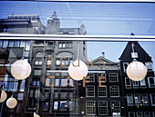 Old Flemish houses reflected on window of coffee shop. Amsterdam. Holland