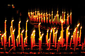 Burning candles in Notre Dame cathedral. Paris. France