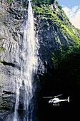 Helicopter by Trou de Fer cascading waterfall. Réunion Island (France)