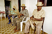 Local people making straw hats with pandanus leaves. Martinique island. French antilles (caribbean)