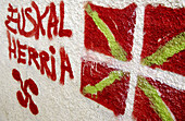 Ikurriña (Euskal Herria flag) and lauburu (basque symbol) graffiti. Gipuzkoa. Euskadi. Spain.