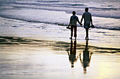 Couple strolling. Hendaye beach. Aquitaine. France.