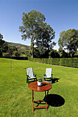 Table and loungers on grass. Osseja, Pyrénées-Orientales, France