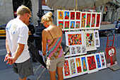 Tourists buying art. Las Ramblas. Barcelona. Spain.