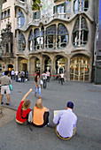 Tourists in front of Batlló House (1904-06 by Gaudí), Barcelona. Catalonia, Spain