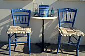 Santorini, Greece, two chairs in the village of Oia.