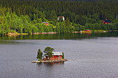 Small island with red wooden house in the lake Hetoegeln near Gaeddede, Jaemtland, northern Sweden