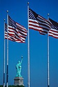 US flags and Statue of Liberty. New Jersey. USA
