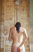  Adult, Adults, Back view, Bare, Bathroom, Bathrooms, Body care, Color, Colour, Contemporary, Female, Human, Hygiene, Indoor, Indoors, Inside, Interior, Naked, Nude, Nudes, Nudity, One, One person, People, Person, Persons, Rear view, Shower, Showers, Stan