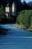 river Inn (En) with houses and spire of Susch, Engadin, Grisons, Switzerland