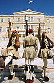 Soldiers (Evzones) on guard in the Monument to the Unknown Soldier and Parliament (Royal Palace). Syntagma Square. Athens. Greece