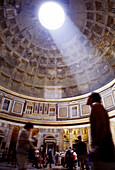 Interior shot of Pantheon dome, light streaming in. Rome, Lazio, Italy