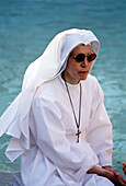 Nun in front of the Trevi Fountain, Rome. Lazio, Italy