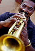 Man playing trumpet. Panaji. Goa. India