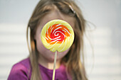 Girl (3-4 years) holding a lollipop, Munich, Germany