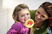 Girl (3-4 years) holding a lollipop, Munich, Germany
