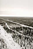 Aerial view of the train tracks and power lines running through open taiga into Churchill, Manitoba, Canada.