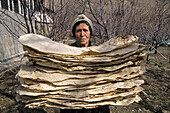 Woman carrying lavash (Armenian cracker bread), Bjni. Armenia
