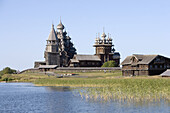 Church of the Intercession of the Mother of God, Pokrovskaia Tserkov, 1764. Church of Transfiguration, Preobrajenskaia Tserkov, 1714. Tower clock, 1874. Kizhi Island. Onega lake, Karelia. Russia.