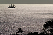 French West Indies (FWI), Guadeloupe, Basse-Terre Island: Silhouetted Sailing Ship / Caribbean Sea