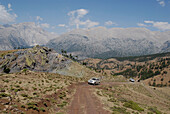 Two 4x4 vehicles, Landscape between Kozluca and Tashan, mountain pass of Divrik Dag, Highlands of Zamanti, Taurus Mountains, Turkey, Europe