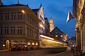 Zurich Limmatquai, Old City center at town hall, Grossmunster, tram, street cafes at dusk