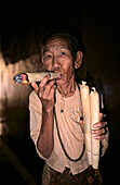 Woman smoking giant cheroot. Bagan. Burma