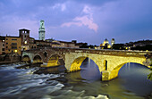 Verona at night. Ponte di Pietra and Cathedral at the back. Veneto, Italy