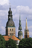 Church towers in Riga: (left to right) Cathedral, Anglican Church and St. Peter s Church; old town from Vansu bridge on Daugava river. Riga, Latvia