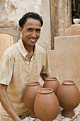 Morocco. Atlantic Coast. Safi: Colline des Potiers.Potter s Hill. Artisan with pottery