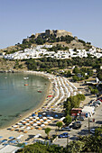Harbor. Beach view with Acropolis of Lindos. Late Afternoon. Lindos. Rhodes. Dodecanese, Greece
