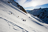 Group of skiers freeriding in Val Strem, Sedrun, Grisons, Switzerland