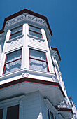 Victorian house, white with red trim, against blue sky, San Francisco, California, USA