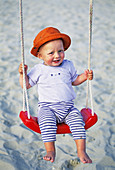 Little one year old boy on swing