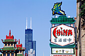 Chinatown signs and John Hanchock Tower in background. Chicago. Illinois, USA