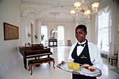 Waitress with a snack in the white room in Nottoway Plantation. Louisiana. USA