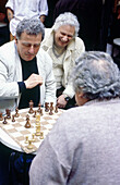 Men playing chess at café terrace. Rome. Italy.